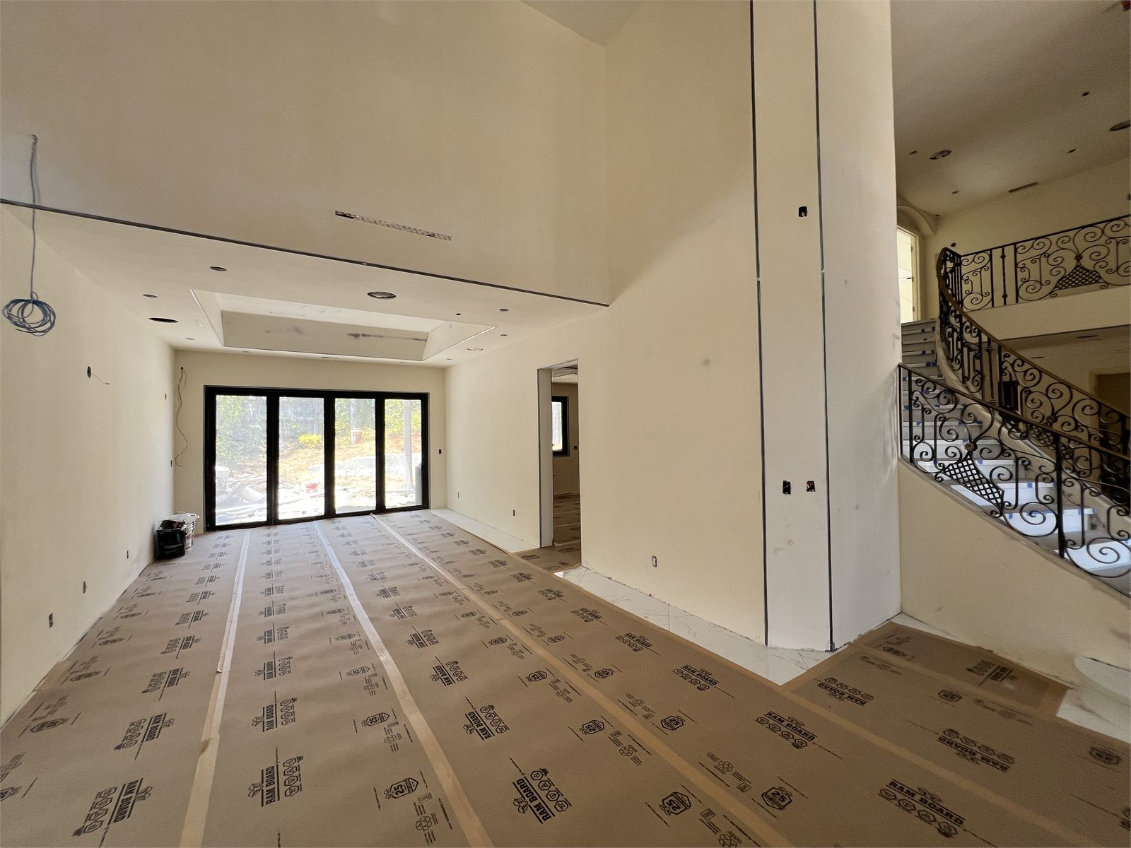 Interior under construction: exposed wall studs, pink batt insulation, and an HVAC unit